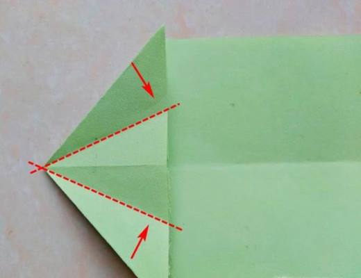 再沿着另外两条虚线将三角形的上层向中间折出折痕